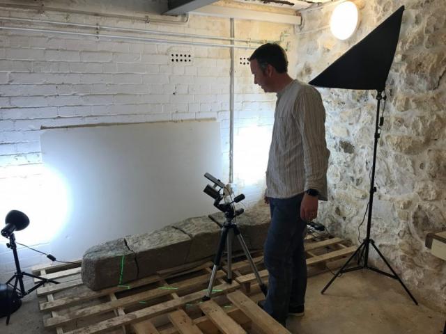 Archaeologist Tom Goskar carrying out close-range laser scanning on the stone.